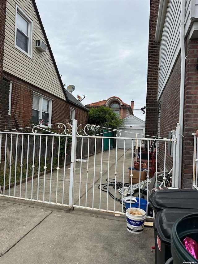 view of gate featuring an outbuilding