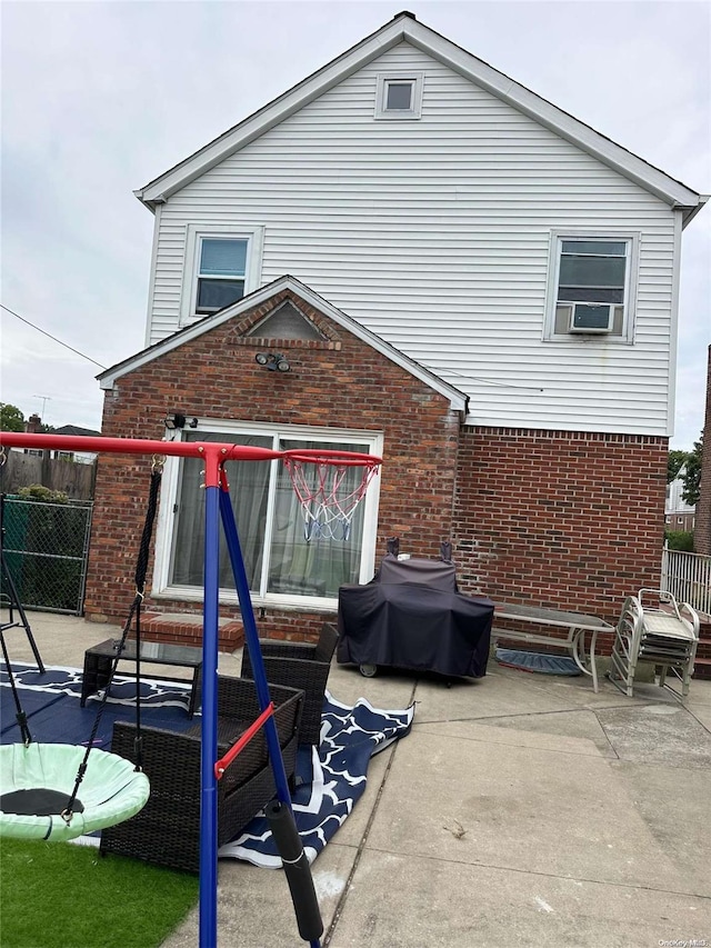 rear view of property featuring a patio area and cooling unit