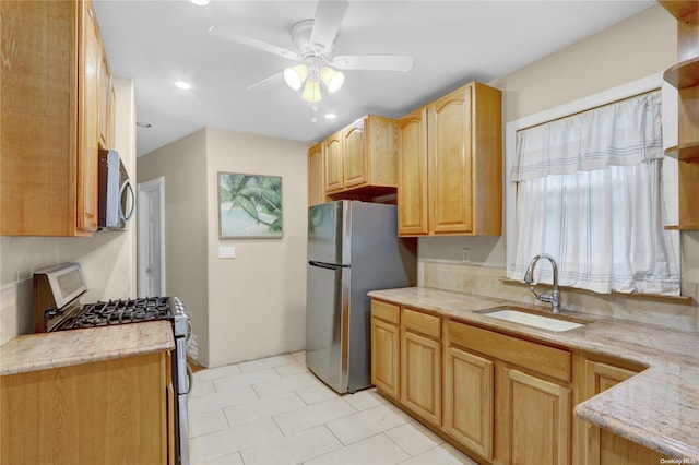 kitchen featuring ceiling fan, light brown cabinetry, sink, and appliances with stainless steel finishes