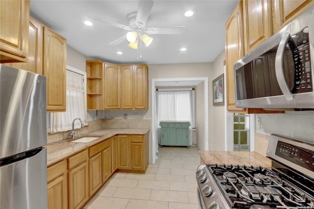 kitchen featuring ceiling fan, sink, light brown cabinets, stainless steel appliances, and light tile patterned flooring