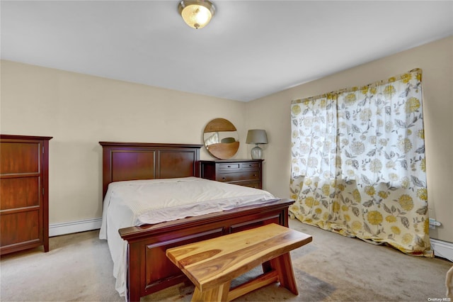 bedroom featuring baseboard heating and light carpet