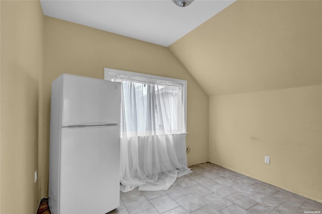 interior space featuring white fridge and lofted ceiling