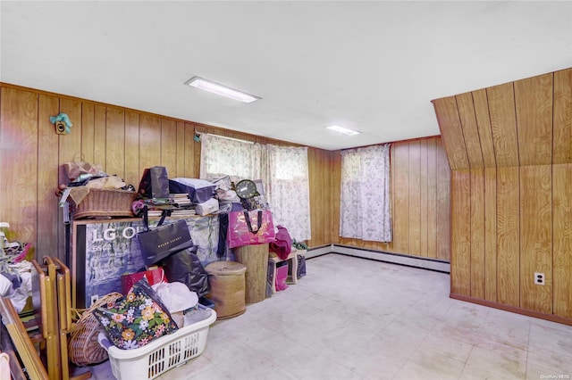 interior space featuring a baseboard radiator and wood walls