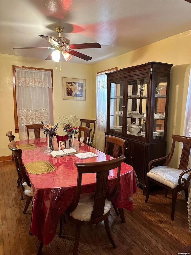 dining space with ceiling fan and dark hardwood / wood-style floors