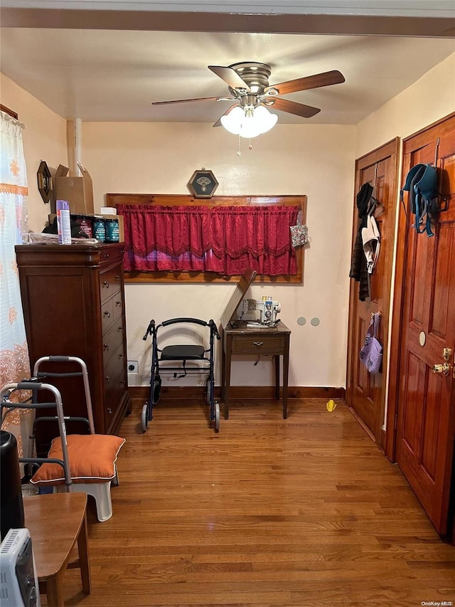 misc room with ceiling fan and light hardwood / wood-style floors