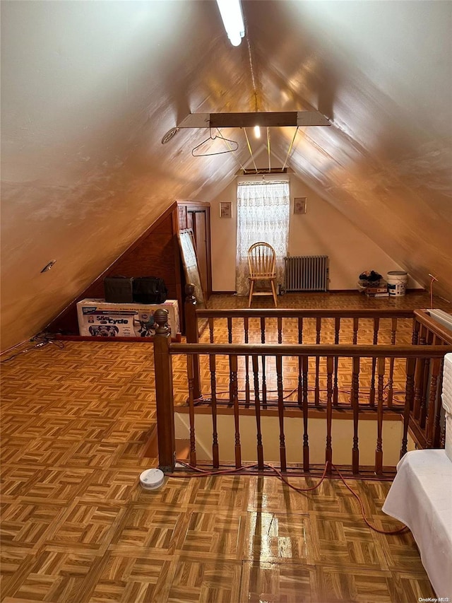 bonus room with parquet floors, radiator, and vaulted ceiling