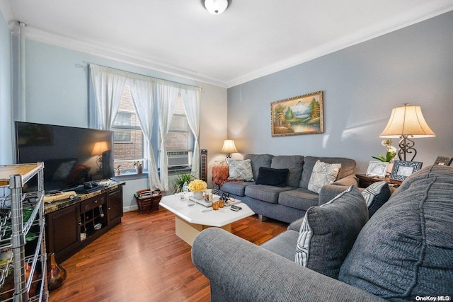 living room featuring ornamental molding and wood finished floors