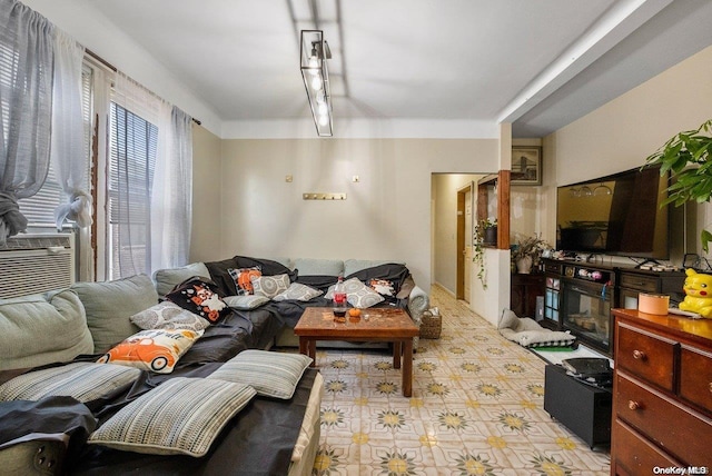 living room featuring cooling unit and a fireplace