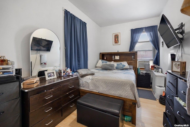 bedroom with light hardwood / wood-style flooring and cooling unit