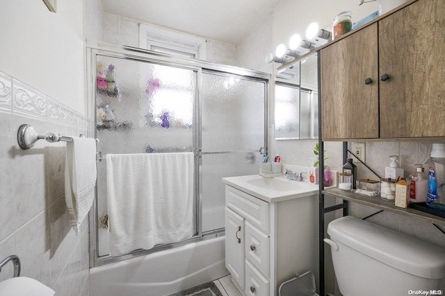 full bathroom with vanity, toilet, and enclosed tub / shower combo