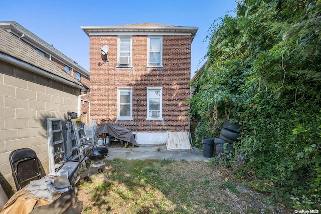 back of house featuring brick siding