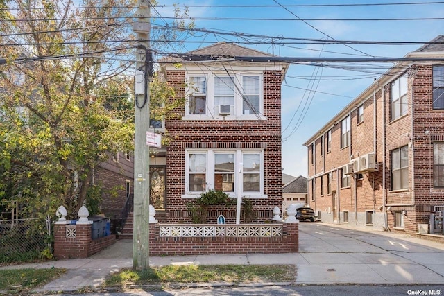 view of front of house featuring a fenced front yard and brick siding