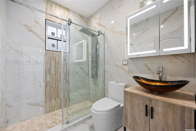 bathroom with walk in shower, vanity, toilet, and tile walls