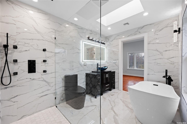 bathroom featuring vanity, a skylight, separate shower and tub, and tile walls