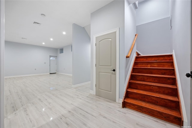 staircase with hardwood / wood-style flooring