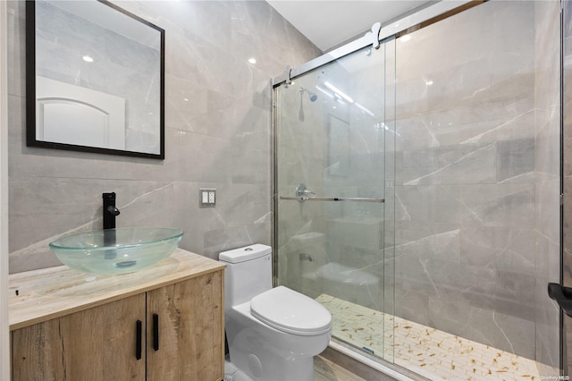 bathroom with tasteful backsplash, an enclosed shower, toilet, vanity, and tile walls