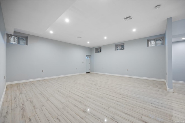 basement with light hardwood / wood-style flooring