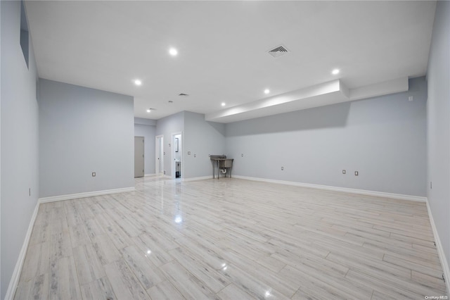 basement with light hardwood / wood-style floors