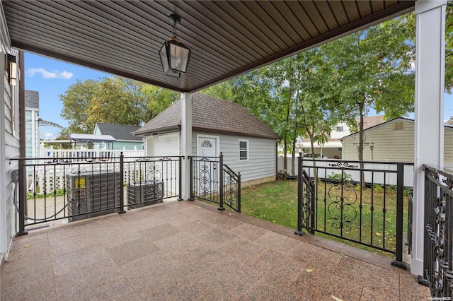 view of patio / terrace with a garage and an outdoor structure