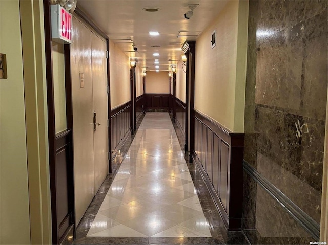 133-38 Sanford Ave Unit 9C, Flushing, NY 11355 - hallway featuring a wainscoted wall, a decorative wall, and light tile patterned floors