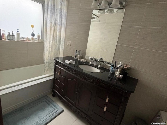 133-38 Sanford Ave Unit 9C, Flushing, NY 11355 - full bathroom with tile walls, decorative backsplash, vanity, tile patterned flooring, and shower / bath combo