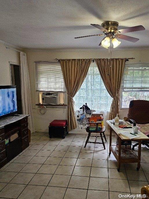 interior space featuring a textured ceiling, cooling unit, and ceiling fan