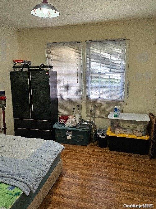 bedroom featuring hardwood / wood-style flooring and a textured ceiling