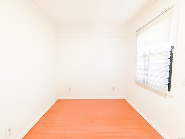 spare room featuring hardwood / wood-style flooring and ornamental molding