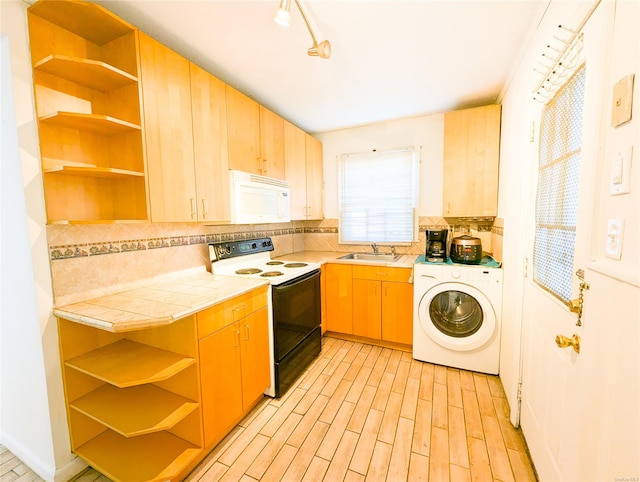 kitchen with washer / dryer, white appliances, tile countertops, and backsplash