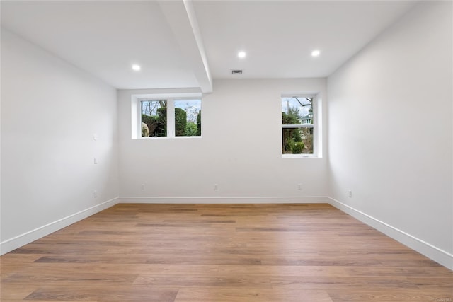 unfurnished room featuring light hardwood / wood-style flooring and a wealth of natural light