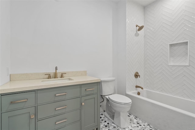 full bathroom featuring tiled shower / bath, vanity, toilet, and tile patterned floors