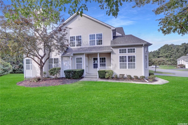 front facade featuring covered porch and a front yard