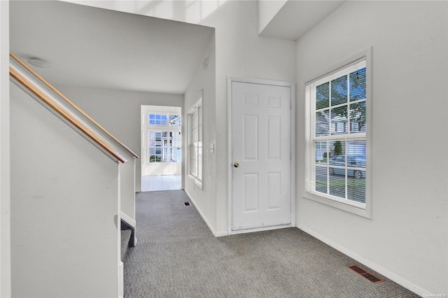 foyer entrance featuring carpet flooring