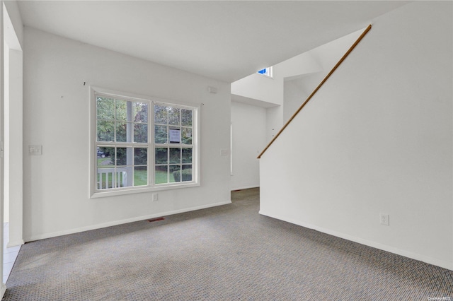 unfurnished living room with carpet