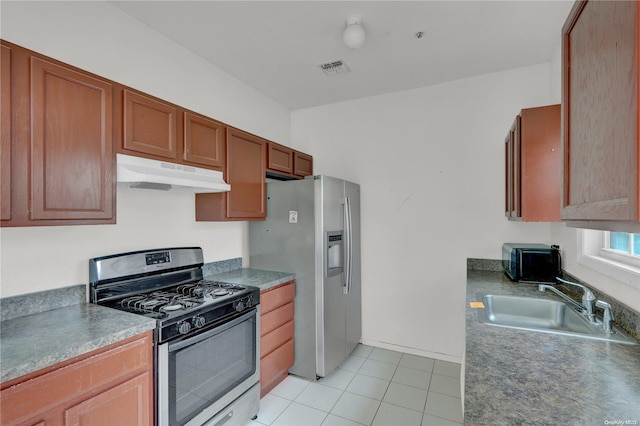 kitchen with sink, light tile patterned flooring, and stainless steel appliances