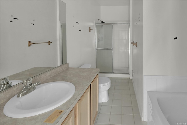 full bathroom featuring toilet, vanity, tile patterned floors, and independent shower and bath