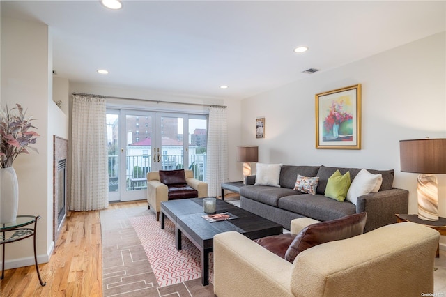 living room featuring light wood-type flooring and french doors