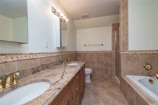 full bathroom featuring tile patterned floors, vanity, separate shower and tub, tile walls, and toilet