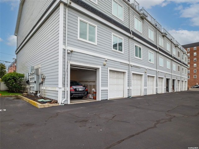 view of side of home with a garage