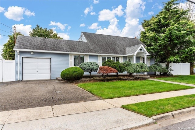 view of front of home with a front lawn and a garage