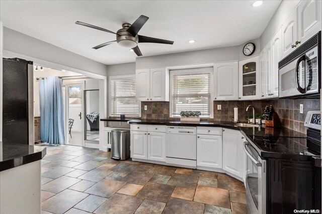 kitchen with sink, white cabinetry, stainless steel appliances, and tasteful backsplash