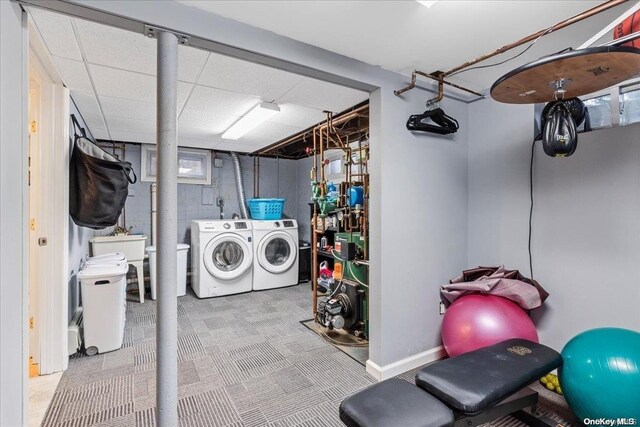 clothes washing area with washing machine and clothes dryer