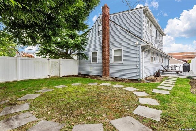 view of side of home featuring a yard