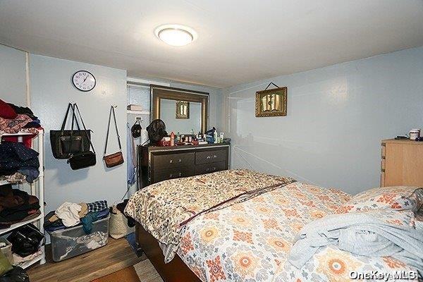 bedroom with wood-type flooring