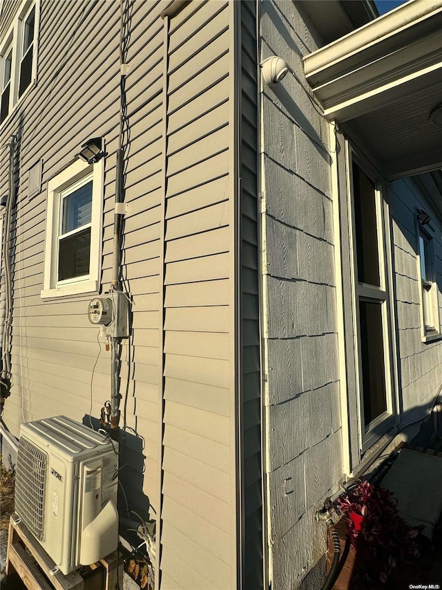 view of side of home featuring ac unit