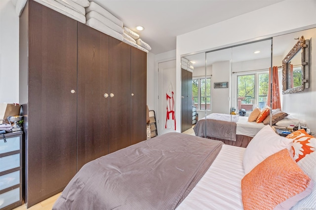 bedroom with a closet and light hardwood / wood-style floors