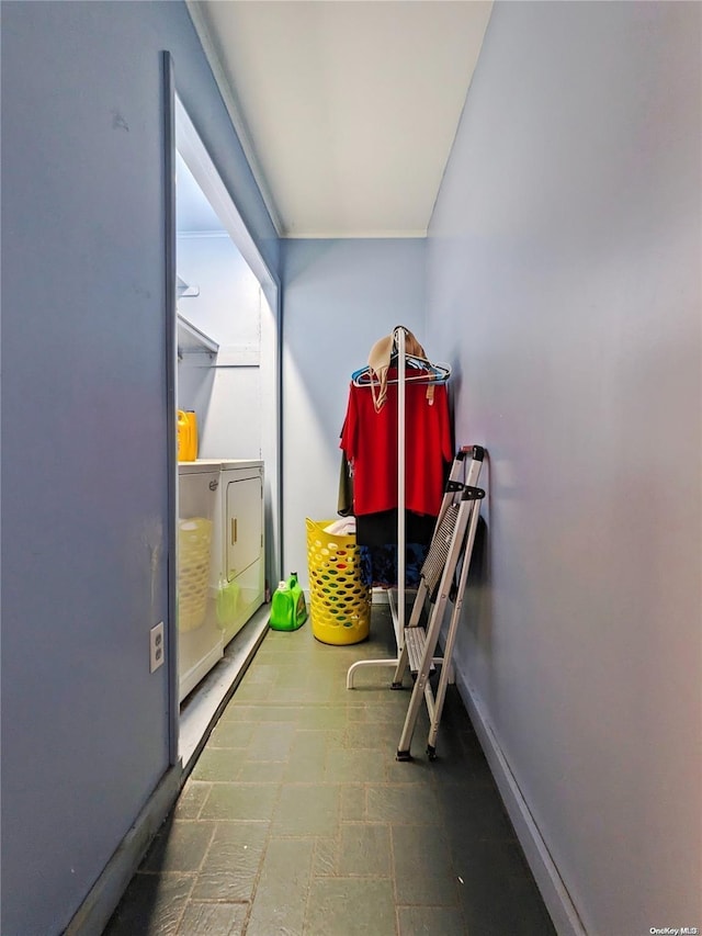 interior space featuring tile patterned floors, washer and dryer, and baseboards