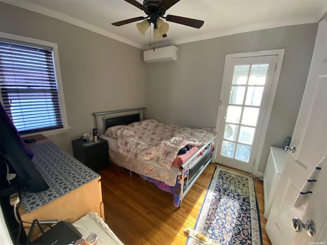 bedroom with a wall mounted air conditioner, ceiling fan, wood-type flooring, and crown molding