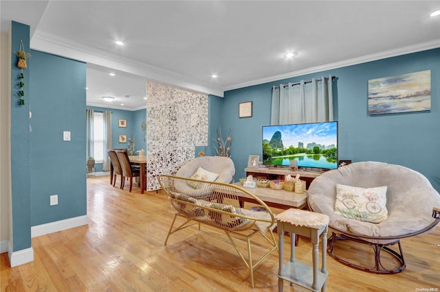 sitting room with light hardwood / wood-style flooring and ornamental molding