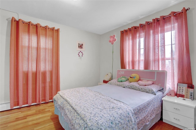 bedroom with wood-type flooring